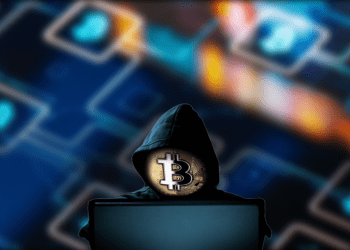 Hacker on computer with Bitcoin (Blockchain) Background