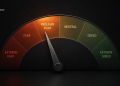 Semicircular emotion gauge showing fear to greed, with labels like extreme fear, regular fear, neutral, greed, and extreme greed; dark background.