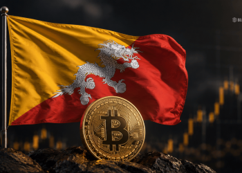 Flag of Bhutan waving beside a large Bitcoin coin on rocky ground with a dark background, symbolizing crypto in Bhutan.