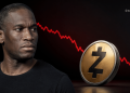 Man looks to the left beside a large gold cryptocurrency coin as a red downward-trending price chart appears in the dark background.