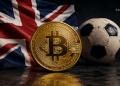 Bitcoin coin in the foreground with a Union Jack flag and a worn soccer ball in the background (Blocknews watermark)