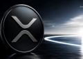 Close-up of a glossy XRP cryptocurrency coin with a silver logo, set against a dark, futuristic background with a light trail on the right.