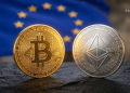 Gold Bitcoin coin and silver Ethereum coin set on a dark surface with a blurred European flag in the background.